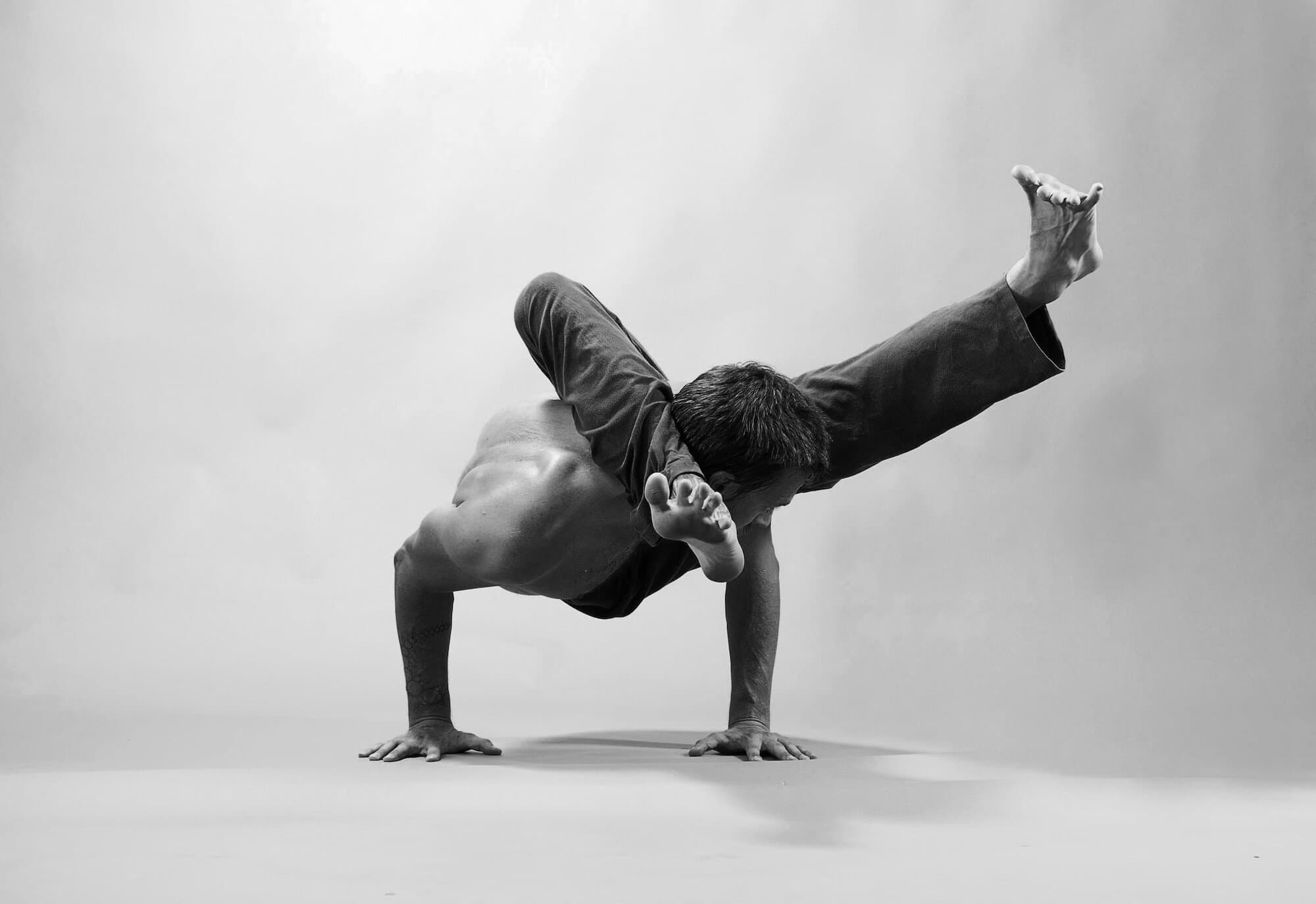 Jason Bowman, yoga teacher, in an arm balance pose
