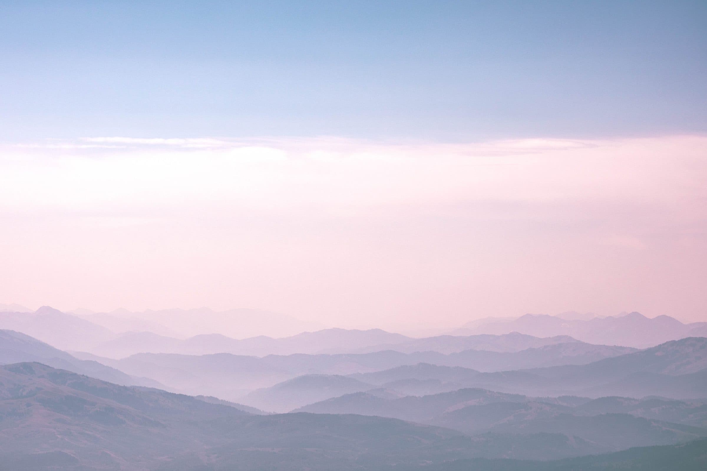 Layered mountain ridges in pink and blue haze, fine art photograph by Jason Bowman
